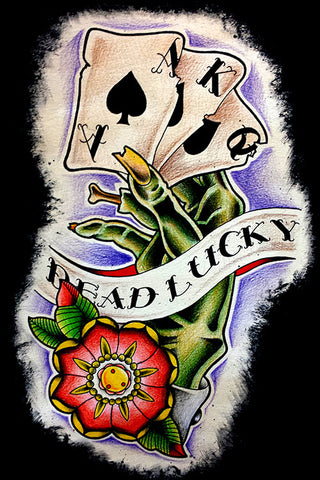 painted image of a Green hand holding playing cards with tattoo style banner reading Dead Lucky.