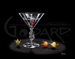 Painted image by Michael Godard of animated fruit and a martini glass with a slot machine in the stem of the glass on a black background.